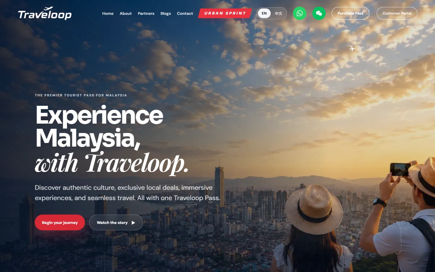 The Traveloop home page: 'Experience Malaysia, with Traveloop.' over a sunset city view, with navigation for partners, Urban Sprint, pass purchase and the customer portal.